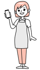 スマホを持って微笑むエプロン姿の若い女性