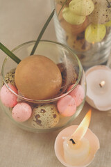 Easter eggs-candles with over eggs in glass background