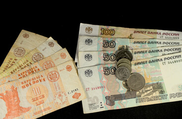 Russian rubles and Moldovan leu on a black background
