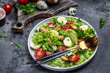 Fresh salad with mussels, quail, egg, conjugate, lime, spinach, lettuce, cherry tomatoes and microgreen. Dietary salad. banner, menu, recipe place for text, top view