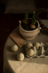 decorative candles in the shape of chicken eggs on the table. decorative candles in the form of quail eggs. candles in the shape of eggs in a tray top view.