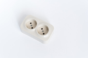 Double socket on a white background. two sockets, united by one monolithic case. The socket has two plug connectors, but is installed in one standard socket. electrical goods store.