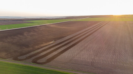 Spring Cultivation of Agricultural Land at sunset