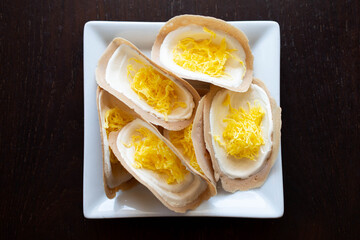 Thai crispy pancake (Khanom bueang) on white plate.