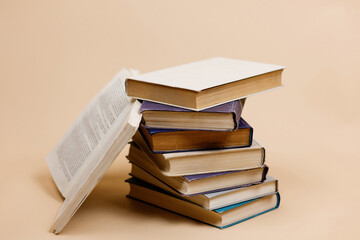 Books on a beige background. A stack of books on a plain background. World Book Day.