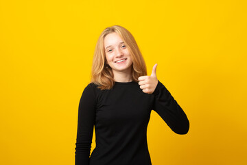 Happy teen girl show hand thumbs up toothy smile.