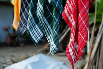 Drying colorful rags hanging from a rope