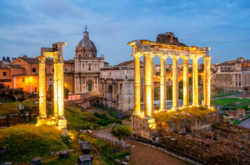 Fototapeta na wymiar View of the temple of Saturn in Roman forum at night, Italy. Ruins of Septimius Severus Arch and Saturn Temple. Rome architecture and landmark.