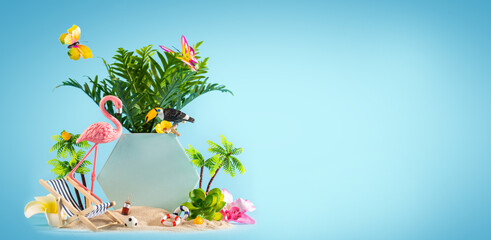 Summer weekend party concept. Flamingo, toucan, palms, tropical flowers and beach accessories on blue background.