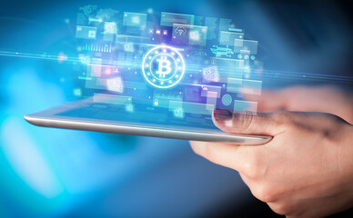 Close-up of a hand using tablet, currency concept