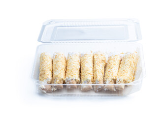 Flaky sweet rolls with cream in plastic pack isolated on white