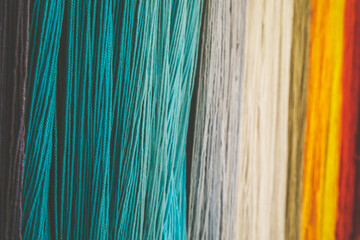 Selective focused on left of Yarn dyed thread or cord or packthread color hang on the wall for background usage. - obrazy, fototapety, plakaty