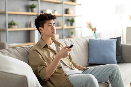 Young Asian Guy Spending Weekend Watching Tv