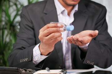 businessman using sanitizer gel on on office desk
