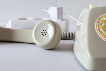 Old technology telephone connected to the electrical network through a plug