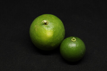 green Lemons fruit. on a black background