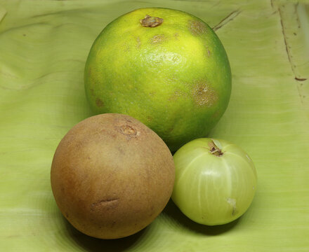 healthy fruits, sweet lime(citrus fruit) , Sapodilla fruit(chikku), gooseberry, green background