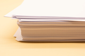 a stack of white office paper on the desktop. Business concept