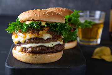 Big hamburger with cheese and green salad