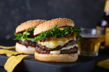 Big hamburger with cheese and green salad