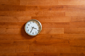 white round clock on wooden floor.Round classic clock lying on a wooden flooring or wooden wall