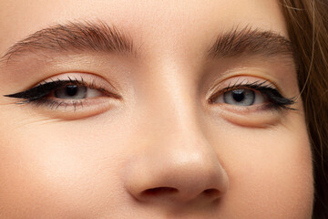 Macro shot of woman's beautiful eye with extremely long eyelashes. Sexy view, sensual look. Female eye with long eyelashes