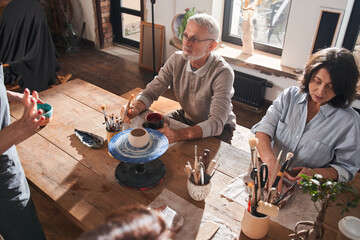 Senior people listening information and feeling inspired while sitting at the table