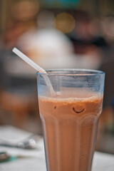 A glass of fresh ice tea with straw