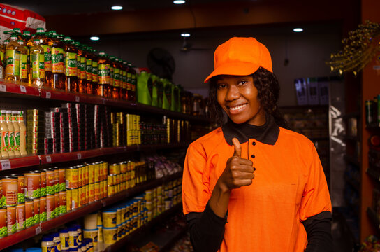 portrait of smiling shop woman smiling and did thumbs up in the supermarket