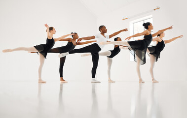 Dance, if youve torn the bandage off. Shot of a group of ballet dancers practicing a routine in a...