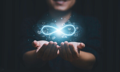 Hands holding virtual infinity with technology icon for symbol of connection to community metaverse world network system concept.