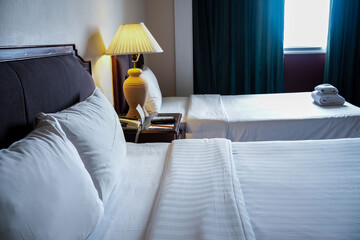Naklejka premium Towels and bedding on double beds in dormitories or guesthouse rooms that are empty.