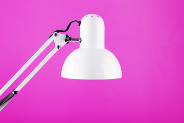 Classic table lamp on pink background with space for text and idea concept