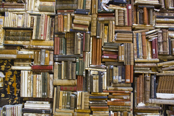 Background of wall covered with lot of books 