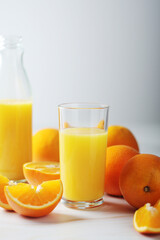 Fototapeta na wymiar Oranges and orange juice in glasses 
