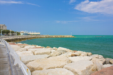 View of embankment and sea with stones in Pesaro, Italy