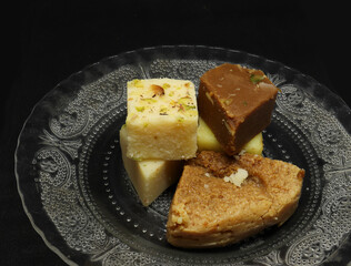 sweets in a plate. on a black background