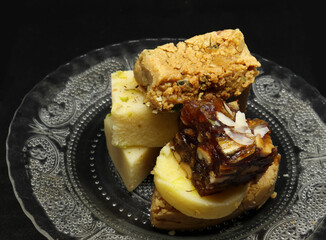 sweets in a plate. on a black background