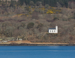 A white church standing on the seashore.