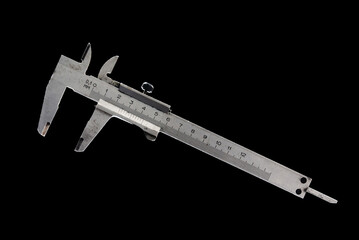 Metal old vernier caliper isolated on black background.