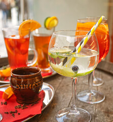delicious fresh cocktails with fruits and blueberries at the bar building on a sunny day