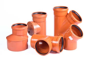 Plumbing fixtures and orange piping parts plastic fittings isolated on a white background