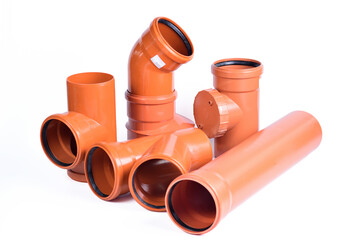 Plumbing fixtures and orange piping parts plastic fittings isolated on a white background