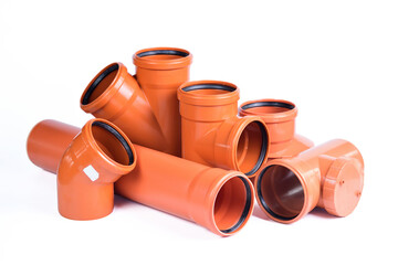 Plumbing fixtures and orange piping parts plastic fittings isolated on a white background