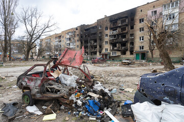 Irpen city, Ukraine, April 11, 2022. War of Russia against Ukraine. Burnt-out car against the background of a burned-out house