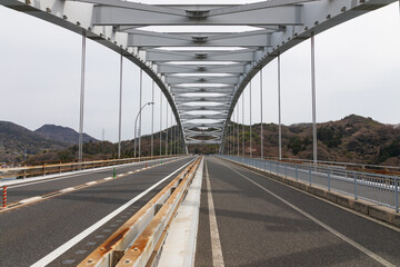 View of Omishima arch bridge from the SHIMANAMI KAIDO cycle route, Hiroshima, Japan