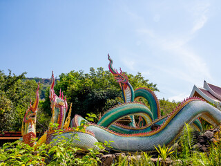 Ubon Ratchathani, THAILAND - February 27, 2022: Buddhist travel . glowing serpent statue with...