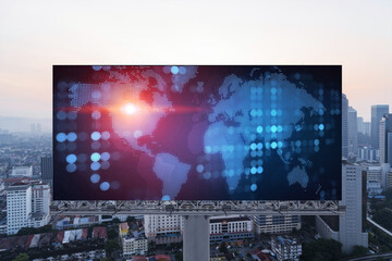 Glowing hologram of Earth planet map on billboard over aerial panoramic cityscape of Kuala Lumpur at sunset, Malaysia, Asia. The concept of international business in KL.