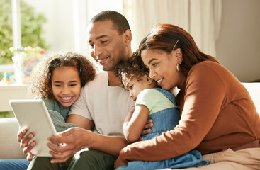 Family comes first. Shot of a young family using a digital tablet at home.