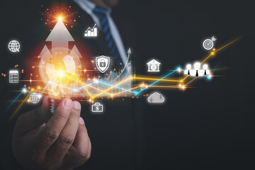 Arrow of business growth. Businessman holding light bulb are planning strategies and analysis profits of a business. Economic growth graph chart. A business strategy, financial, marketing, banking.